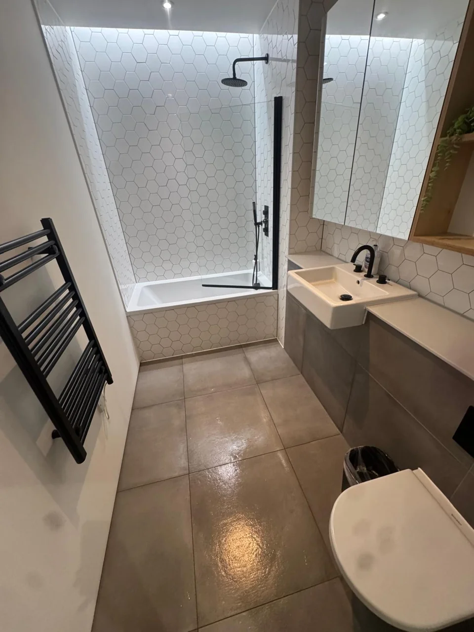 Cleaned Brentford bathroom with shower, basin and tiled floor